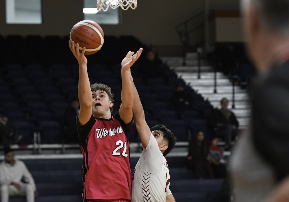 Sir Charles Tupper's Axel Greaves is guarded by Ari Khanna of Enver Creek during the B.C. senior boys Triple-A basketball championships opening round 03.04.26 at the Langley Event Centre. (Photo by Howard Tsumura for Varsity Letters 2026. All Rights Reserved)
